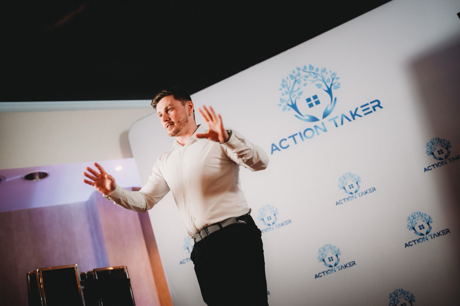 Lewis Hunter on stage at the Action Taker Summit